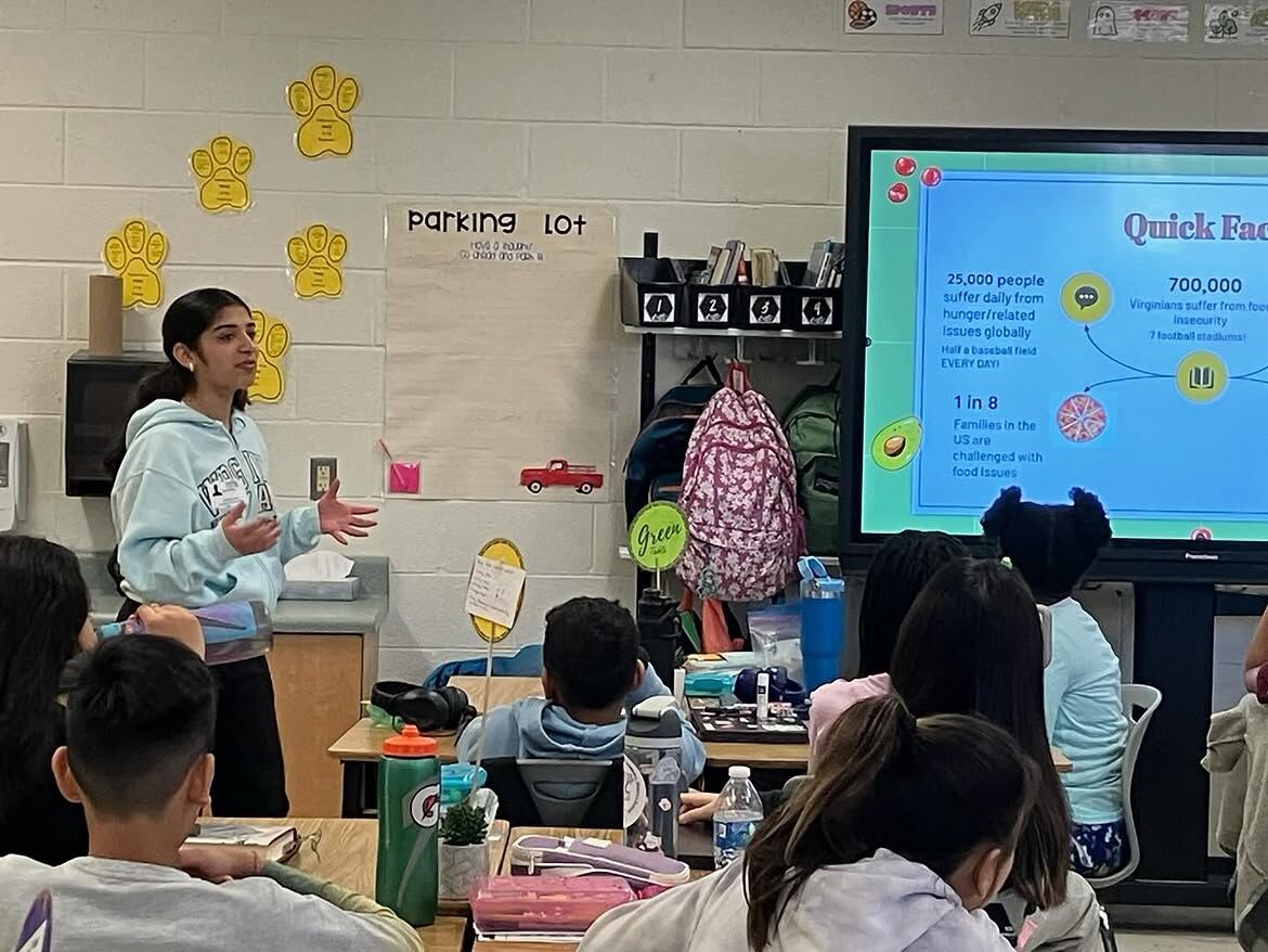 A Second Harvest ambassador presents food insecurity facts to an elementary school class